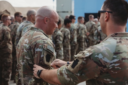 U.S. Soldiers with the 56th Stryker Brigade Combat Team, 28th Infantry Division, deployed as Task Force Paxton, receive their combat patches during a ceremony at Camp Simba, Kenya, March 21, 2024. Officially called the Shoulder Sleeve Insignia-Military Operations in Hostile Conditions, eligible Soldiers are able to wear that insignia on their right shoulder for the rest of their Army career.