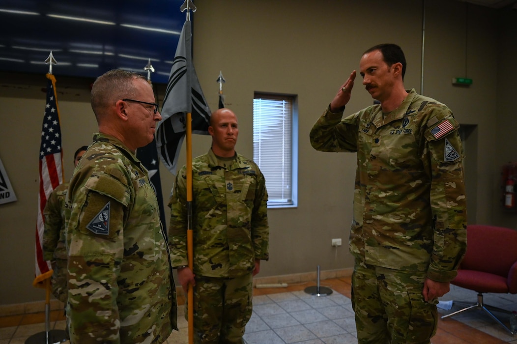 U.S. Space Force Lt. Col. Deane Lake (right), U.S. Space Forces Central combat detachment 3-1 commander, salutes USSF Col. Christopher Putman, SPACECENT commander, during an activation and assumption of command ceremony at an undisclosed location within the U.S. Central Command area of responsibility, March 12, 2024.
