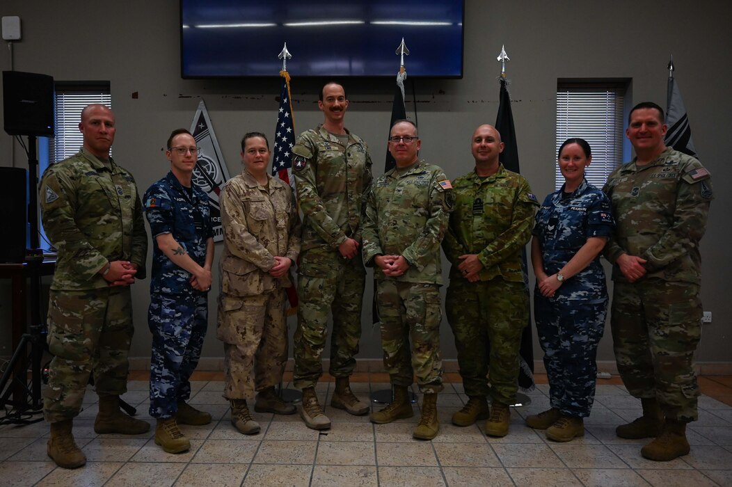 U.S. Space Force Col. Christopher Putman (center right), U.S. Space Forces Central commander, and Lt. Col. Deane Lake (center left), SPACECENT combat detachment 3-1 commander, pose for a photo following an activation and assumption of command ceremony with Royal Australian Air Force and Royal Canadian Air Force service members at an undisclosed location within the U.S. Central Command area of responsibility, March 12, 2024.