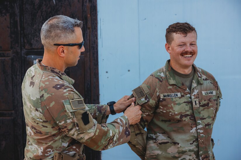 Soldiers with the 56th Stryker Brigade Combat Team, 28th Infantry Division, deployed as Task Force Paxton, receive their combat patches during a ceremony at Camp Simba, Kenya, March 21, 2024. Officially called the Shoulder Sleeve Insignia-Military Operations in Hostile Conditions, eligible Soldiers can wear that insignia on their right shoulder for the rest of their Army career. (U.S. Army photo by Staff Sgt. Jonathan Campbell)