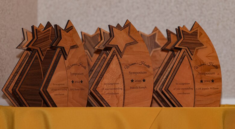 Awards for Women’s Health Symposium 2024 speakers stand on a table at The Clubs at Quantico on Marine Corps Base Quantico, Virginia, March 18, 2024. The symposium covered a range of topics, concerning women’s health with the intent to educate and generate awareness to uniformed and civilian personnel. (U.S. Marine Corps photo by Lance Cpl. David Brandes)