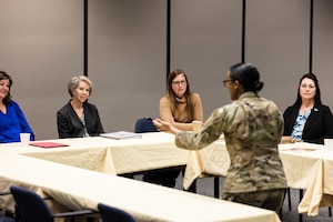Dede Richardson, the wife of Gen. Duke Z. Richardson, commander, Air Force Materiel Command, receives a presentation from Senior Master Sgt. Tanya Sipos, senior enlisted leader, 412th Forces Support Squadron, during a visit to Edwards Air Force Base California, March 26. Sipos explained the unique challenges that Edwards Airmen and their families overcome to complete the 412th Test Wing’s mission. (Air Force photo by Blaine Torres)