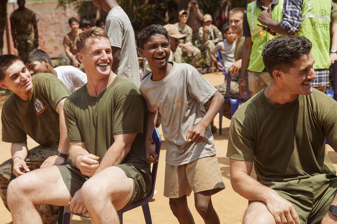 U.S. Marine Corps 1st Lt. Maxwell Gallahan, center left, a platoon commander assigned to Weapons Company, Battalion Landing Team 1/5, 15th Marine Expeditionary Unit, participate in musical chairs at a community relations event during Exercise Tiger TRIUMPH in Visakhapatnam, India, March 22, 2024. Tiger TRIUMPH is a U.S.-India tri-service amphibious exercise focused on humanitarian assistance and disaster relief readiness and interoperability. Tiger TRIUMPH enables U.S. and Indian Armed Forces to improve interoperability and bilateral, joint, and service readiness in the Indian Ocean region and beyond to better achieve mutual regional security objectives. (U.S. Marine Corps photo by 1st Lt. Robert Nanna)