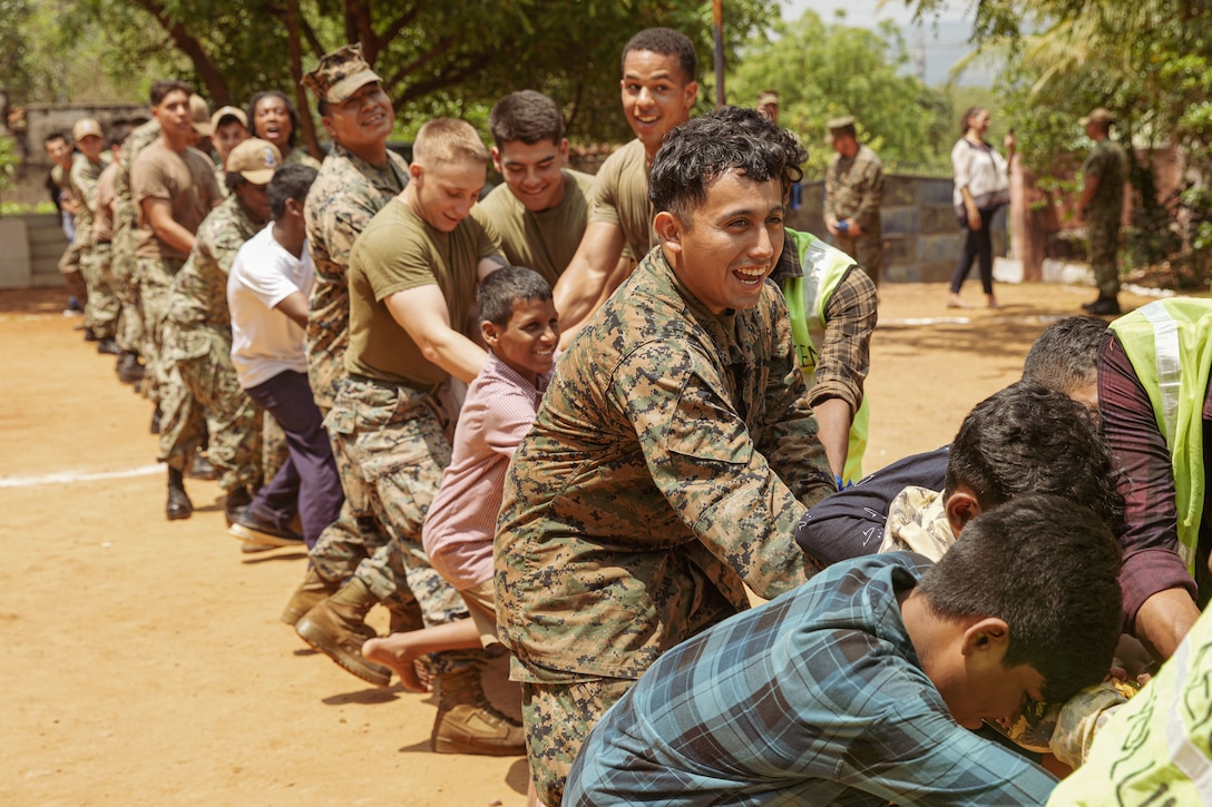 U.S. Marine Corps Lance Cpl. Baruch Longines, a motor transport operator assigned to Combat Logistics Battalion 15, 15th Marine Expeditionary Unit, participates in a tug-of-war competition with children from a foster home at a community relations event during Exercise Tiger TRIUMPH in Visakhapatnam, India, March 22, 2024. Tiger TRIUMPH is a U.S.-India tri-service amphibious exercise focused on humanitarian assistance and disaster relief readiness and interoperability. Tiger TRIUMPH enables U.S. and Indian Armed Forces to improve interoperability and bilateral, joint, and service readiness in the Indian Ocean region and beyond to better achieve mutual regional security objectives. (U.S. Marine Corps photo by 1st Lt. Robert Nanna)