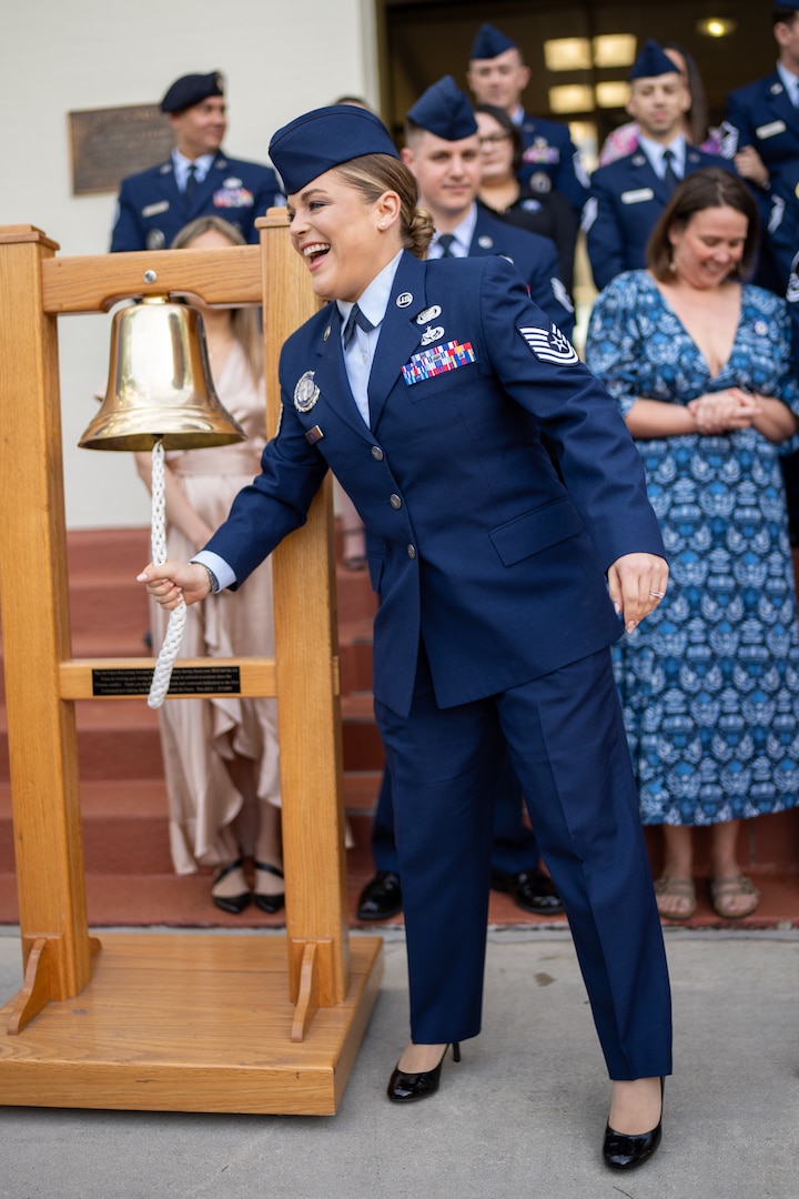 Picture of Tech Sgt. Vicki Martin, ringing a bell