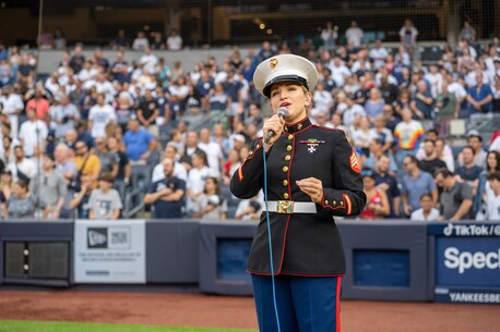 U.S. Marine Corps Sgt. Dana Reminsky, a vocalist with the U.S. Marine Corps Forces Reserve Band, performs God Bless America during the seventh inning stretch at Yankee Stadium, New York City, July 4, 2023. Reminsky performed in front of a sold-out crowd of over 46,000 fans. (U.S. Marine Corps photo by Sgt. Juan Carpanzano)