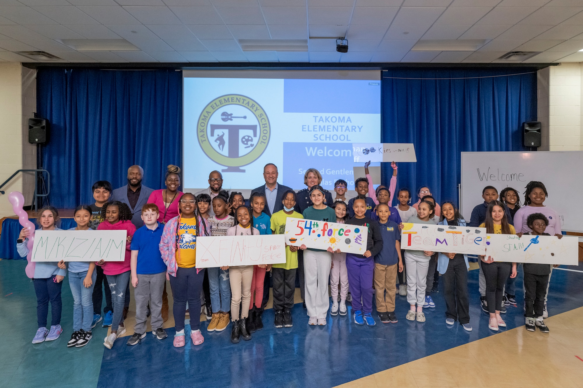 Students at Takoma Elementary School pose with Second Gentleman Douglas Emhoff and Lt. Gen. DeAnna Burt, Space Force Deputy Chief of Space Operations for Operations, Cyber, and Nuclear