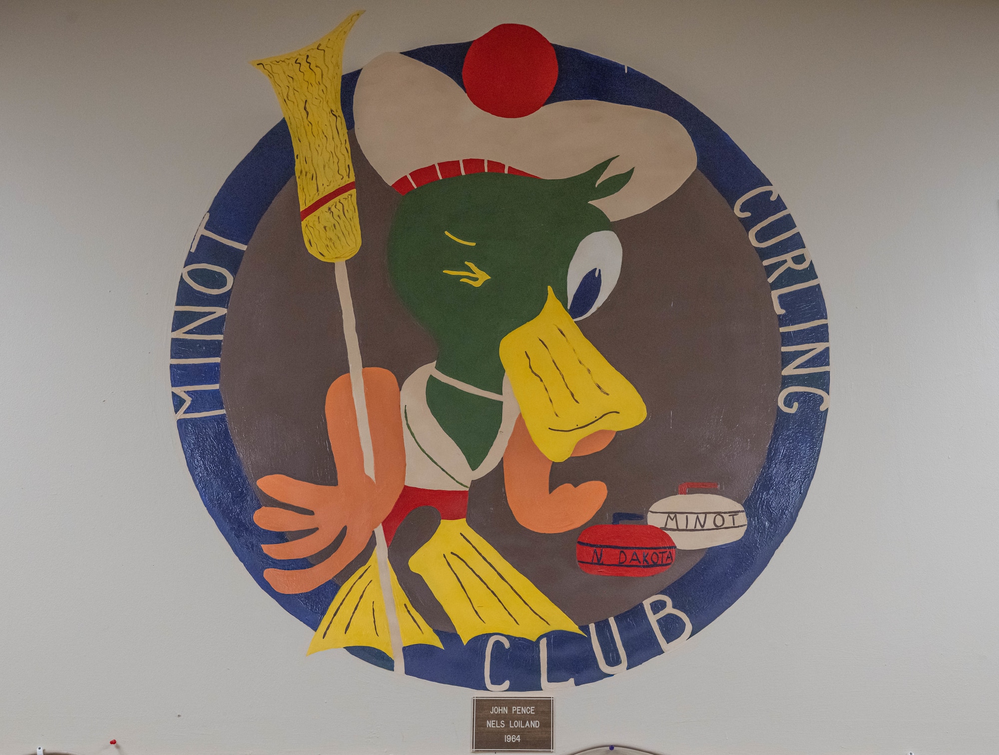 A painting of the Minot Curling Club logo is displayed at the Minot Curling Club, Minot, North Dakota, March 19, 2024. The Minot Curling Club was established in 1905 and provides a venue for members of the Minot AFB Curling League to compete. (U.S. Air Force photo by Airman 1st Class Kyle Wilson)