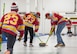 Members of the Lobstahs curling team execute the delivery of a curling stone at the Minot Curling Club, Minot, North Dakota, March 19, 2024. The delivery, or throw, is the process of sliding the curling stone down the sheet of ice and directing it towards the target area. (U.S. Air Force photo by Airman 1st Class Kyle Wilson)