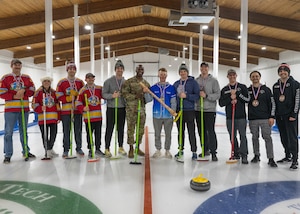 U.S. Air Force Col. Kenneth McGhee, 91st Missile Wing commander (center), and members of the Minot Air Force Base curling league pose for a photo at the Minot Curling Club, Minot, North Dakota, March 19, 2024. McGhee attended the Minot AFB Curling League’s championship game and presented medals to the teams competing. (U.S. Air Force photo by Airman 1st Class Kyle Wilson)