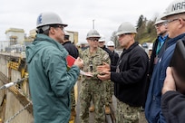 Vice Chief of Naval Operations Adm. Jim Kilby discusses Dry Dock 3 operations with Puget Sound Naval Shipyard & Intermediate Maintenance Facility senior leadership, March 22, 2024, during a tour of PSNS & IMF, in Bremerton, Washington. (U.S Navy photo by Wendy Hallmark)