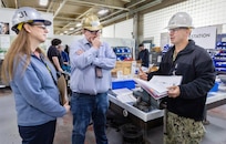 Vice Chief of Naval Operations Adm. Jim Kilby talks with Mike Jeppesen, operations director, Shop 31, Inside Machinist, and Felicienne Griffin, superintendent, Shop 31, Inside Machinist, March 22, 2024, during a tour of Building 431 at Puget Sound Naval Shipyard & Intermediate Maintenance Facility, in Bremerton, Washington. (U.S Navy photo by Wendy Hallmark)