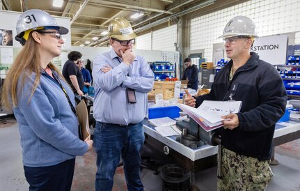 Vice Chief of Naval Operations Adm. Jim Kilby talks with Mike Jeppesen, operations director, Shop 31, Inside Machinist, and Felicienne Griffin, superintendent, Shop 31, Inside Machinist, March 22, 2024, during a tour of Building 431 at Puget Sound Naval Shipyard & Intermediate Maintenance Facility, in Bremerton, Washington. (U.S Navy photo by Wendy Hallmark)