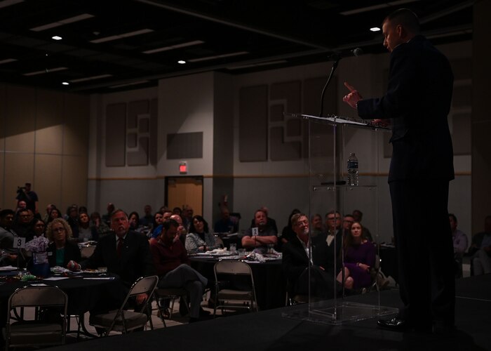 San Angelo Chamber of Commerce members listen to U.S. Air Force Col. Christopher Corbett, 17th Training Wing deputy commander, give a speech during the San Angelo Chamber of Commerce State of Goodfellow luncheon at the McNease Convention Center, San Angelo, Texas, Mar. 19, 2024. The luncheon allowed attendees to hear updates from various San Angelo community members and 17th Training Wing representatives. (U.S. Air Force photo by Airman 1st Class Evelyn J. D’Errico)