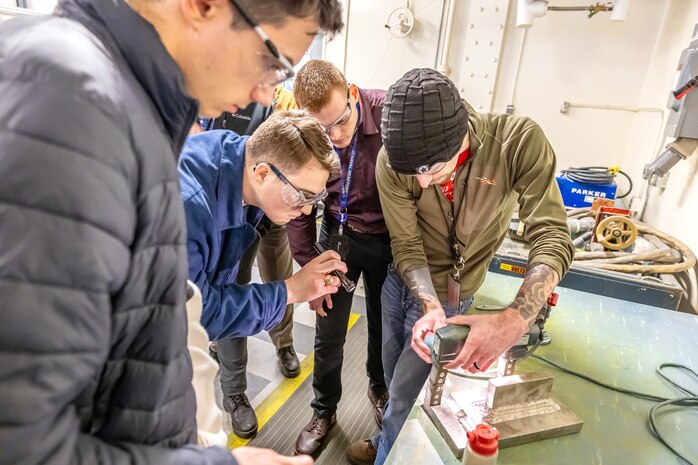 Garrett Colpitts, training leader, Code 135, Quality Assurance, Non-Destructive Testing, conducts a magnetic particle inspection demonstration, Feb. 15, 2024, during an orientation program for new Naval Reactors engineers at Puget Sound Naval Shipyard & Intermediate Maintenance Facility in Bremerton, Washington. (U.S. Navy photo by Jeb Fach)