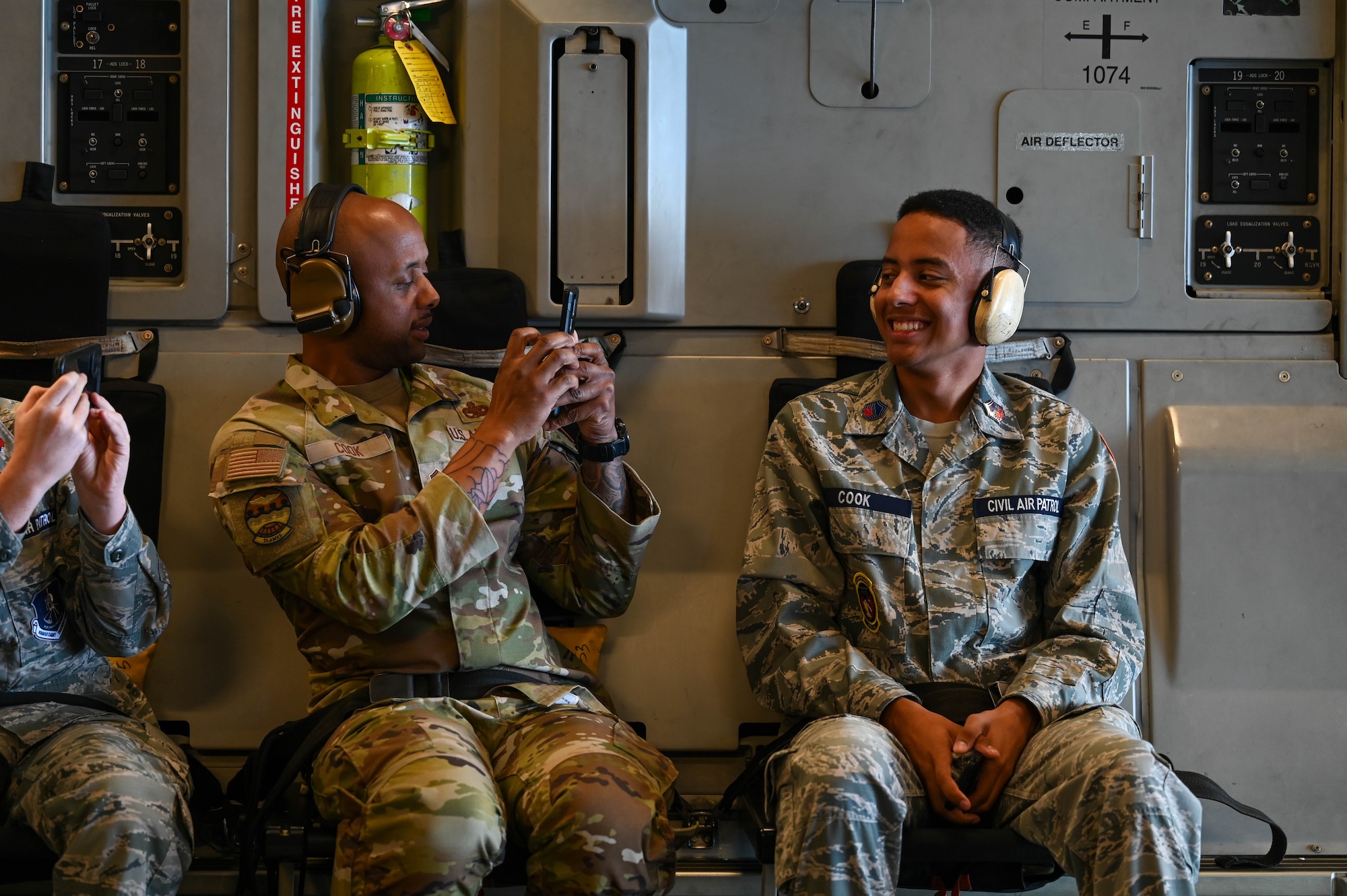 Airman takes photo of son while on an aircraft.