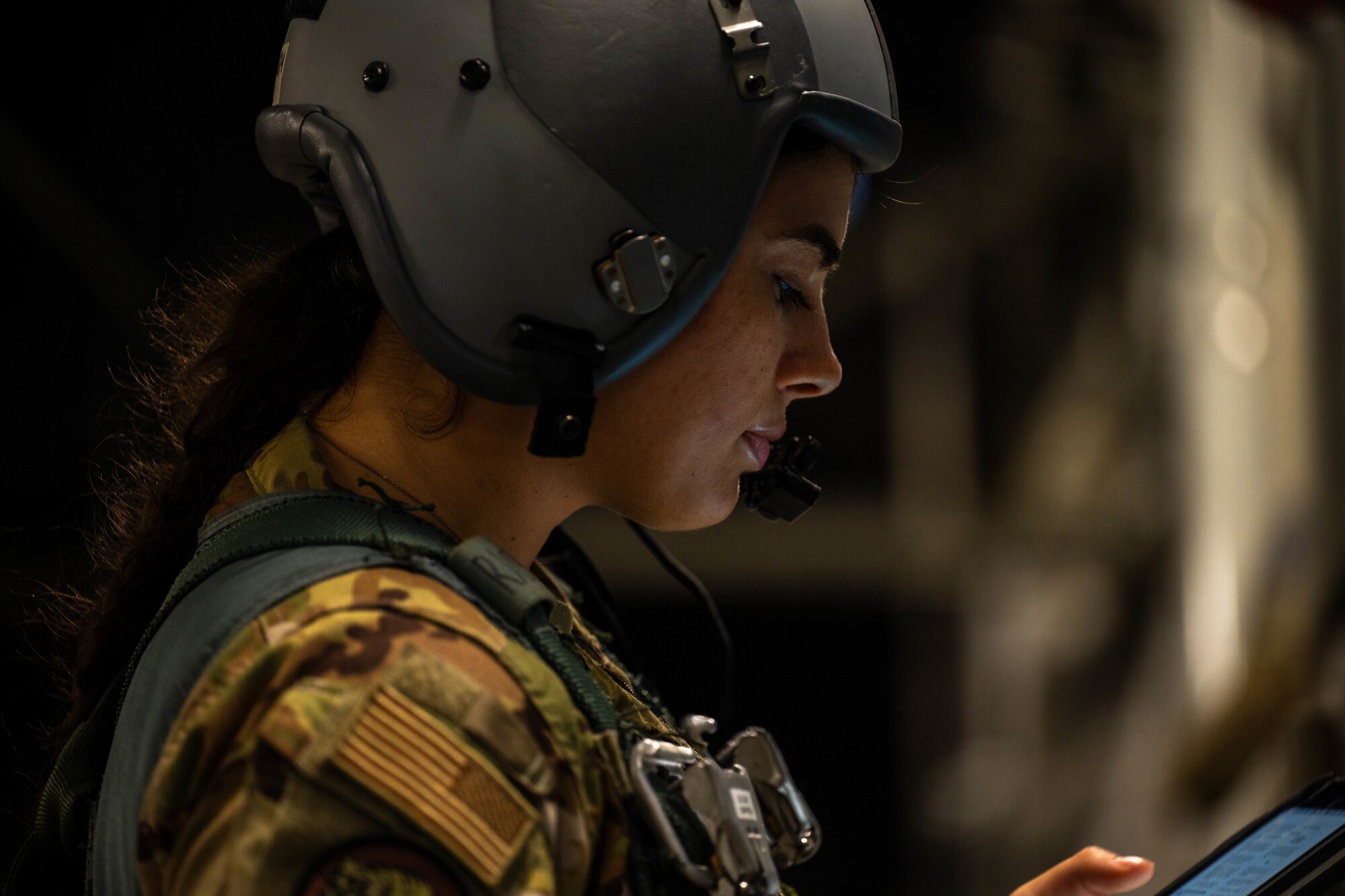Airman looks at electronic checklist device.
