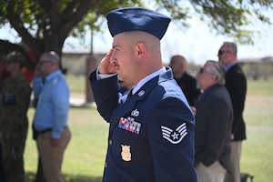 U.S. Air Force Staff Sgt. Jhonny Taborda, 312th Training Squadron instructor, salutes as the national anthem plays at the annual Department of Defense Fallen Firefighter Memorial, Goodfellow Air Force Base, Texas, March 22, 2024. The 17th Training Wing hosts an annual memorial to honor firefighters who put their lives on the line. (U.S. Air Force photo by Airman James Salellas)