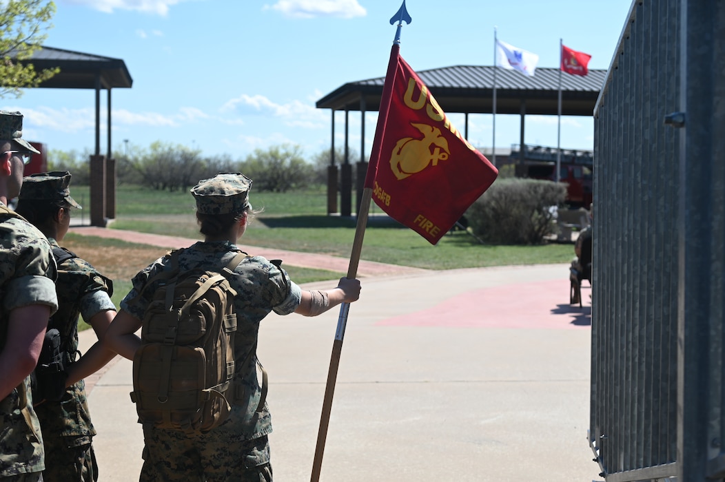 U.S. Marine Corps Lance Cpl. Dana Warner, Fire Company 6th Platoon student, stands at parade rest with the company guidon during the annual Department of Defense Fallen Firefighter Memorial at Goodfellow Air Force Base, Texas March 22, 2024. This year’s event honored the families of five fallen DoD firefighters who paid the ultimate sacrifice defending our nation. (U.S. Air Force photo by Airman James Salellas)