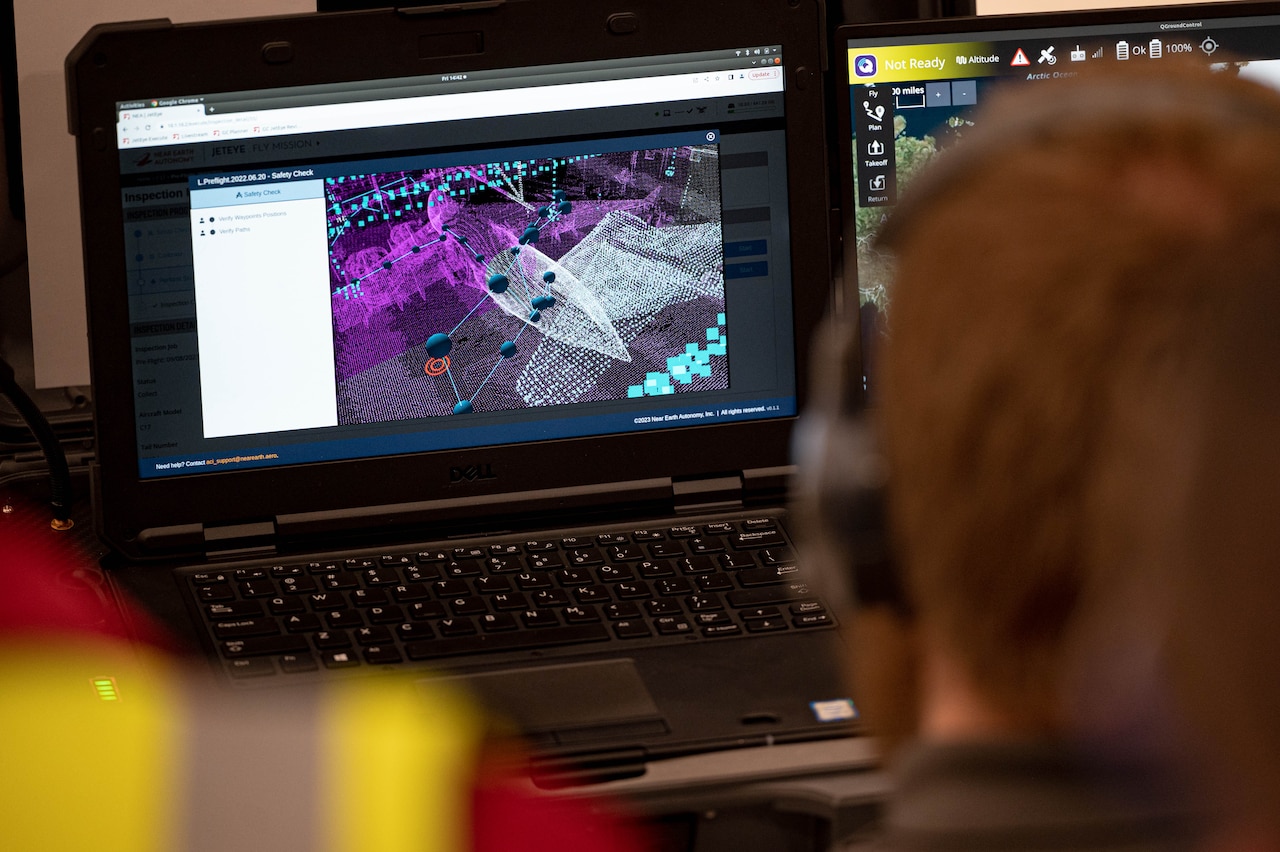 A drone operator looks at a computer image.