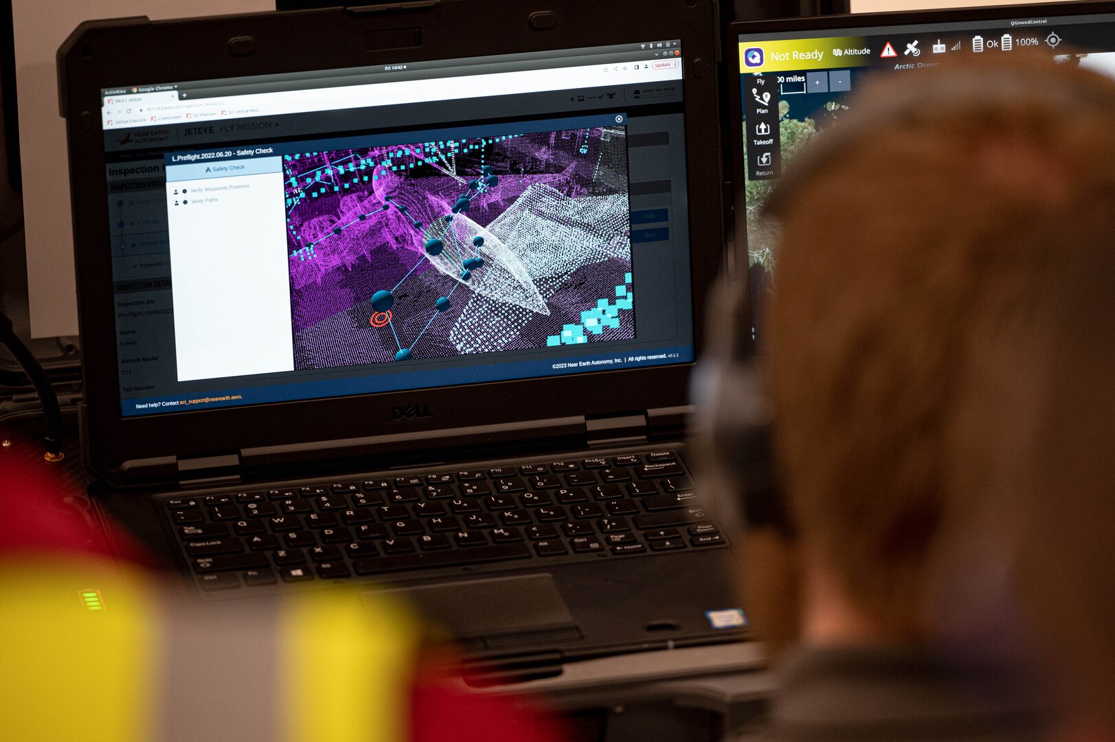 A drone operator looks at a computer image.