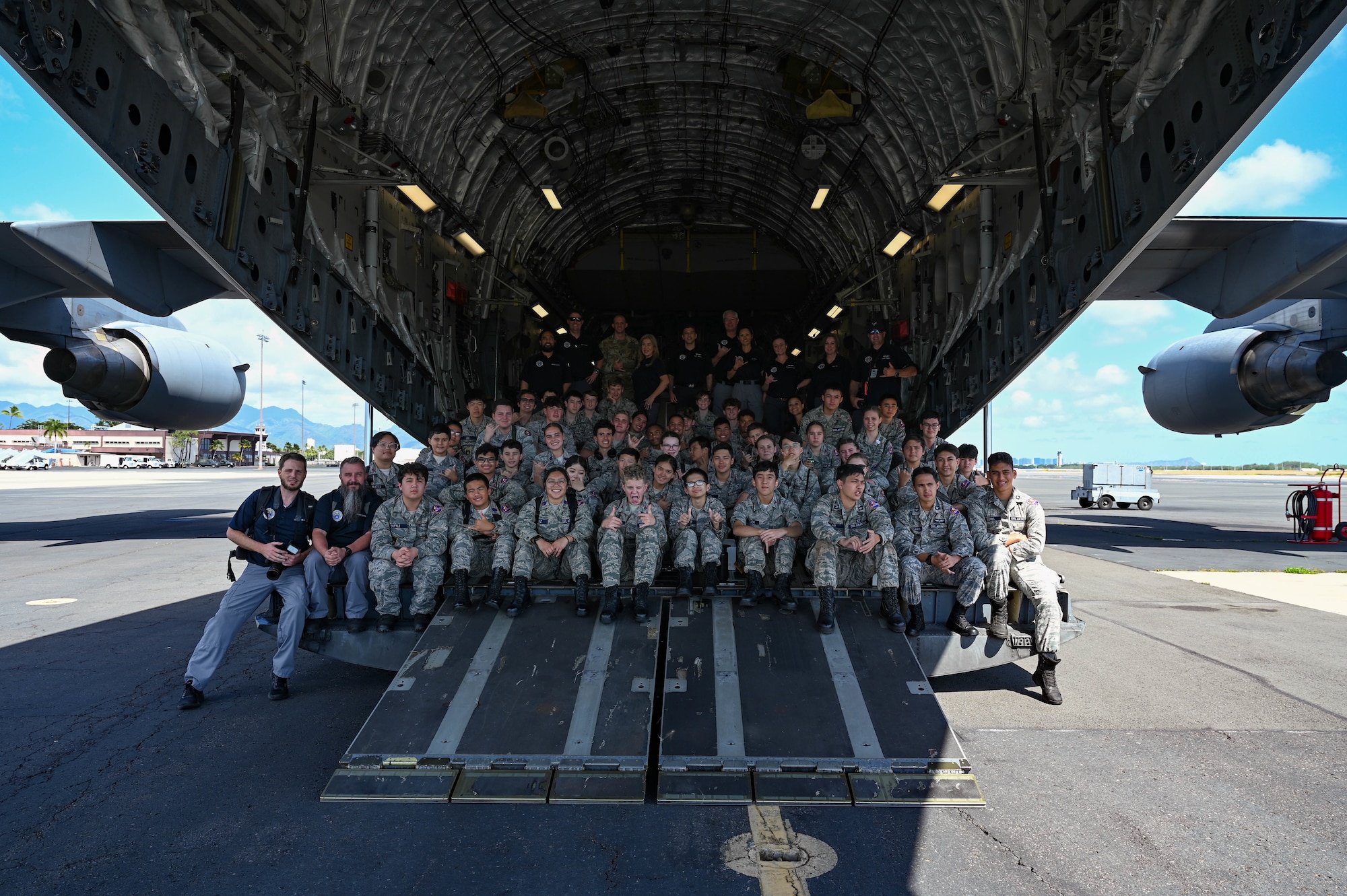 Civil Air Patrol Cadets and Senior Civil Air Patrol members take a group photo inside of an aircraft.