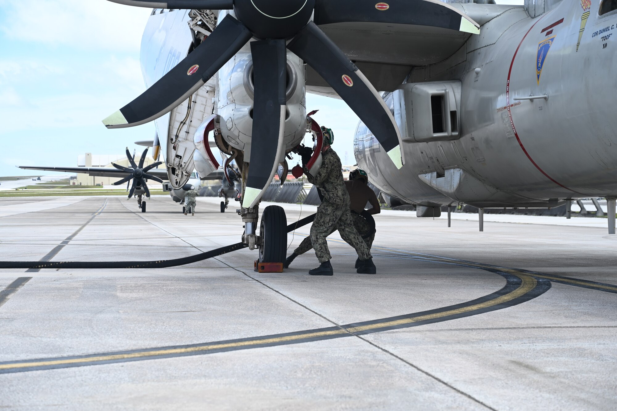 Sailors begin refueling the E-2D Hawkeye aircraft.