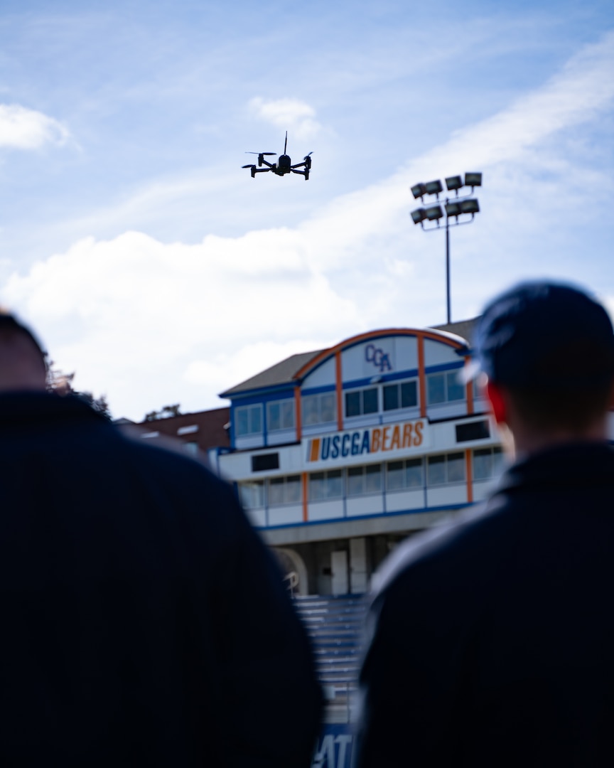 Students look up at a drone in flight during a training course at the Coast Guard Academy, New London, Conn, Feb 21, 2023. The Coast Guard Short Ranged Unmanned Aerial Systems (SR-UAS) program is designed to create designated pilots and integrate drone capabilities into various missions. (U.S. Coast Guard photograph by Petty Officer 3rd Class Matt Thieme)