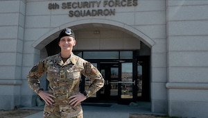 Capt. Julie Breault, 8th Security Forces Squadron Operations OIC poses for a photo in front of a grey building