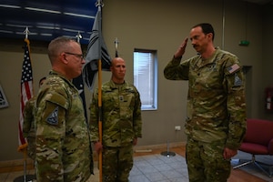 U.S. Space Force Lt. Col. Deane Lake (right), U.S. Space Forces Central combat detachment 3-1 commander, salutes USSF Col. Christopher Putman, SPACECENT commander, during an activation and assumption of command ceremony at an undisclosed location within the U.S. Central Command area of responsibility, March 12, 2024.