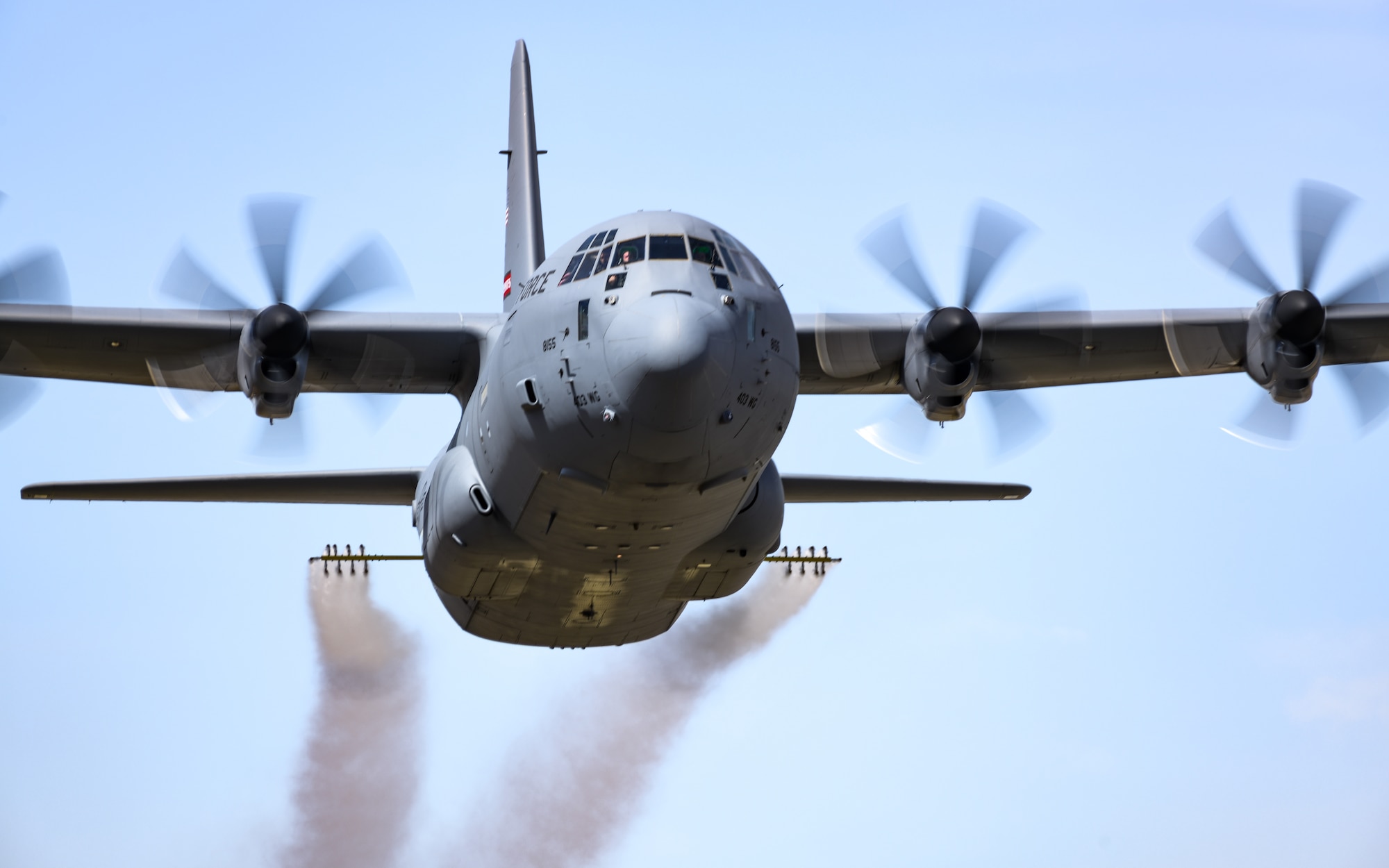 A C-130J-30 Super Hercules aircraft from Keesler Air Force Base, Mississippi, sprays water during a low pass at Youngstown Air Reserve Station, Ohio, as part of a flight test of the 910th Airlift Wing's unique electronic modular aerial spray system, March 25, 2024.
