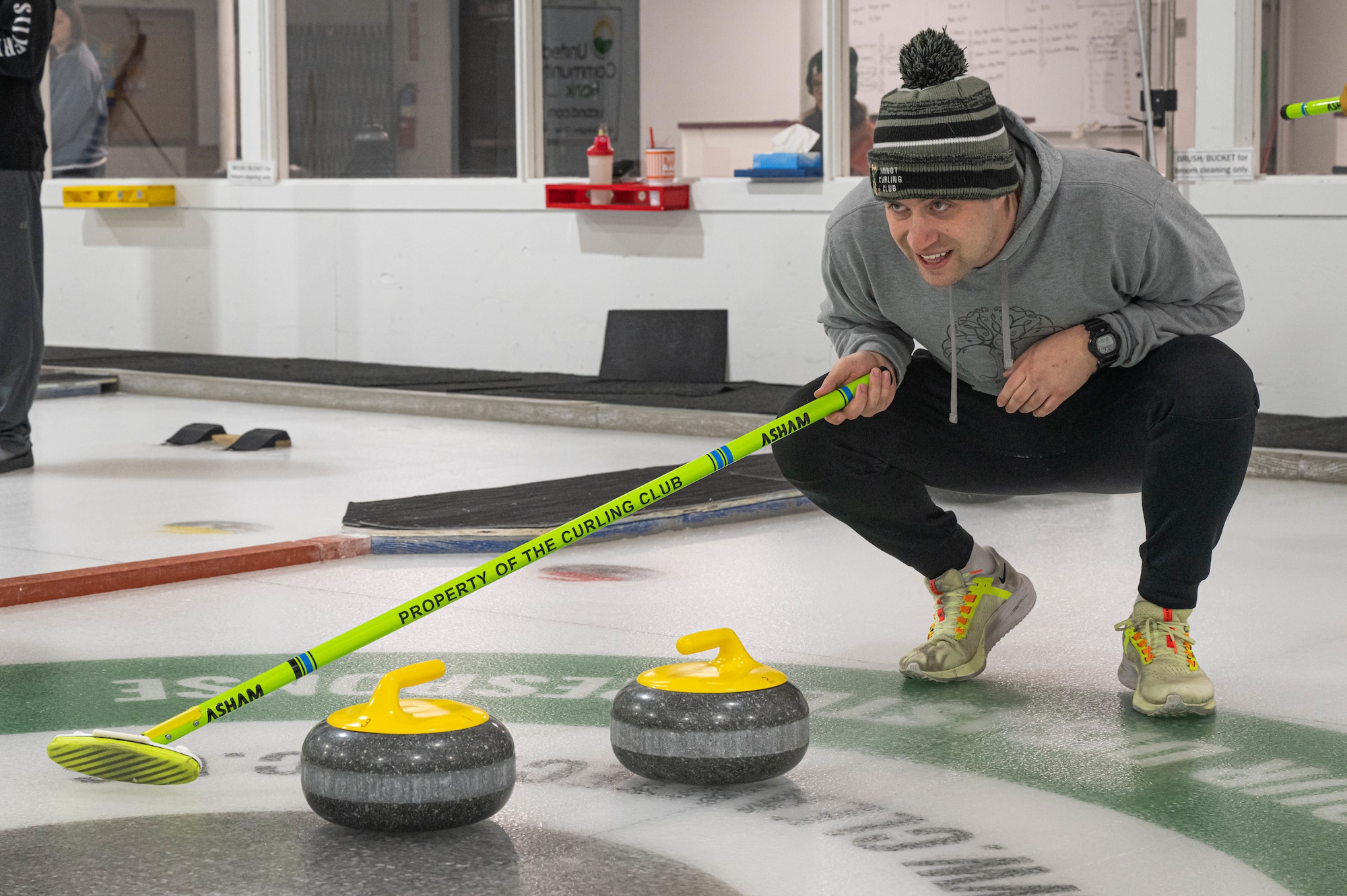 U.S. Air Force 1st Lt. Graysen Trandem, 740th Missile Squadron assistant flight commander, performs skip duties for his team at the Minot Curling Club, Minot, North Dakota, March 19, 2024. As the skip, Trandem stood in the target area and communicated to his teammates where they should aim the delivery of the curling stone. (U.S. Air Force photo by Airman 1st Class Kyle Wilson)