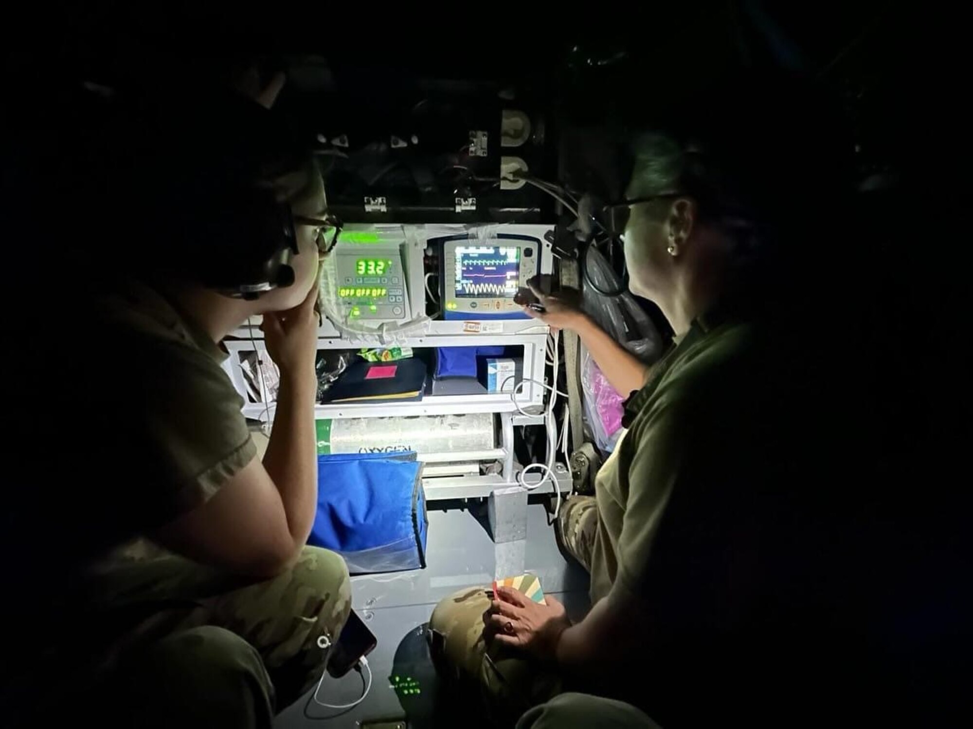 airmen look at vital equipment