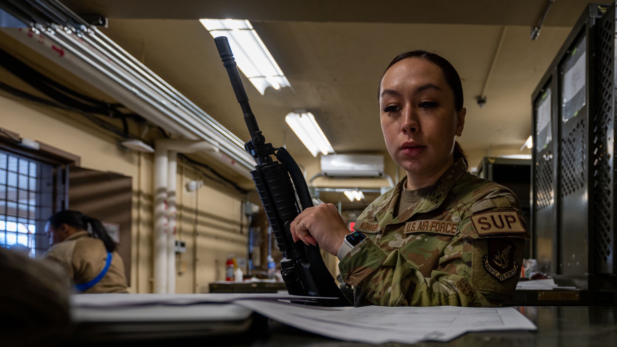 Tech. Sgt. Victoria Kohagen inspects paperwork before checking out an M4 carbine rifle in preparation for Beverly Sentinel 24-1.