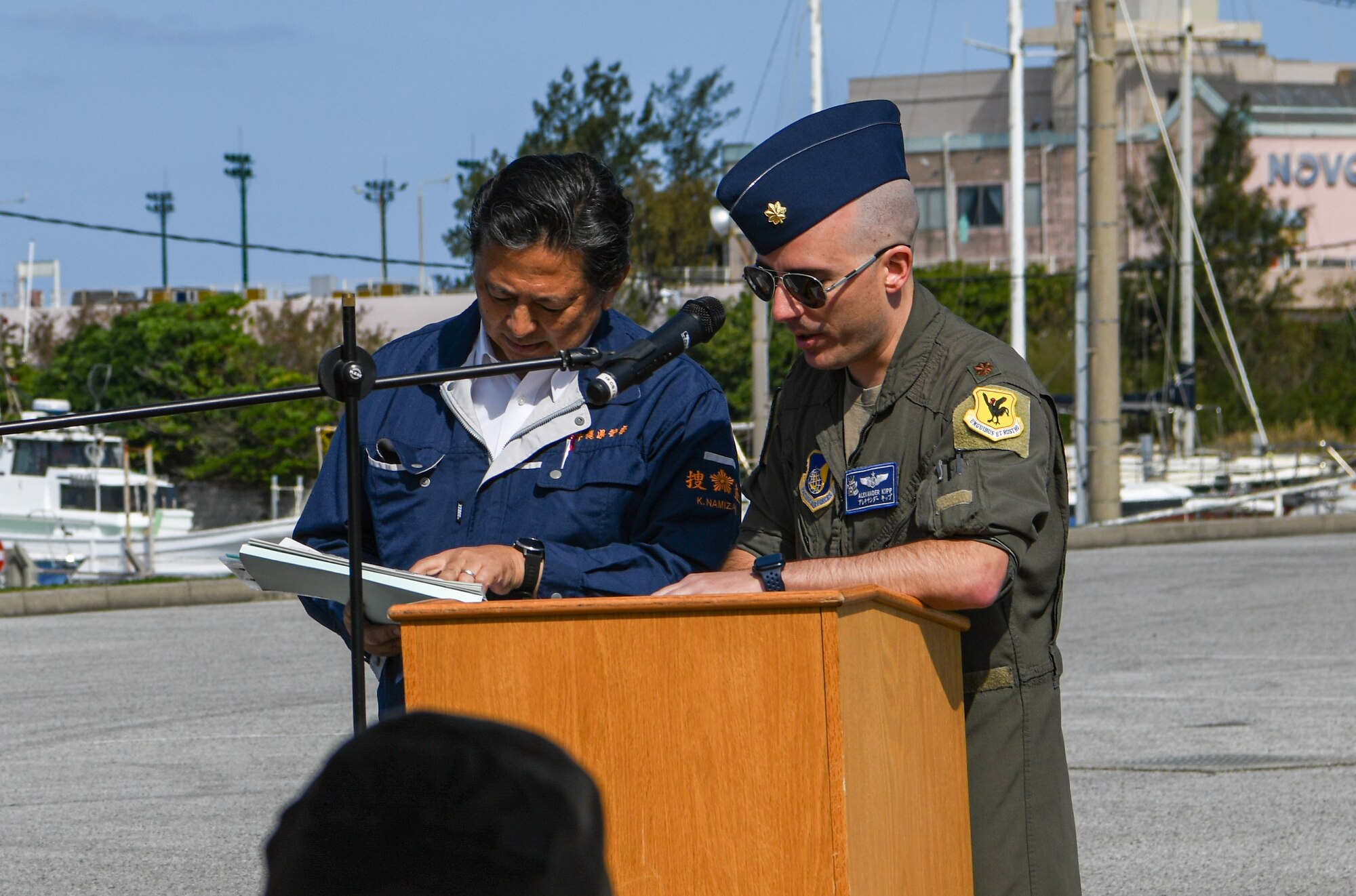 U.S. Air Force Major Alexander Kipp, right, 18th Wing Plans and Programs deputy chief, gives opening remarks.