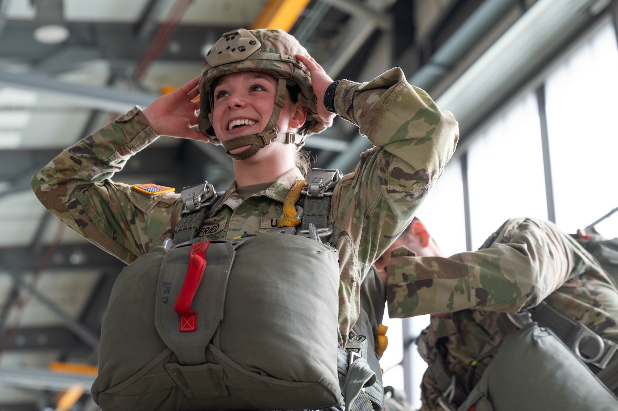 U.S. Army Spc. Jasmine Siegfried, 5th Quartermaster Company parachute rigger, is inspected before a jump during a Fly Like a Girl event at Ramstein Air Base, Germany, March 20, 2024.