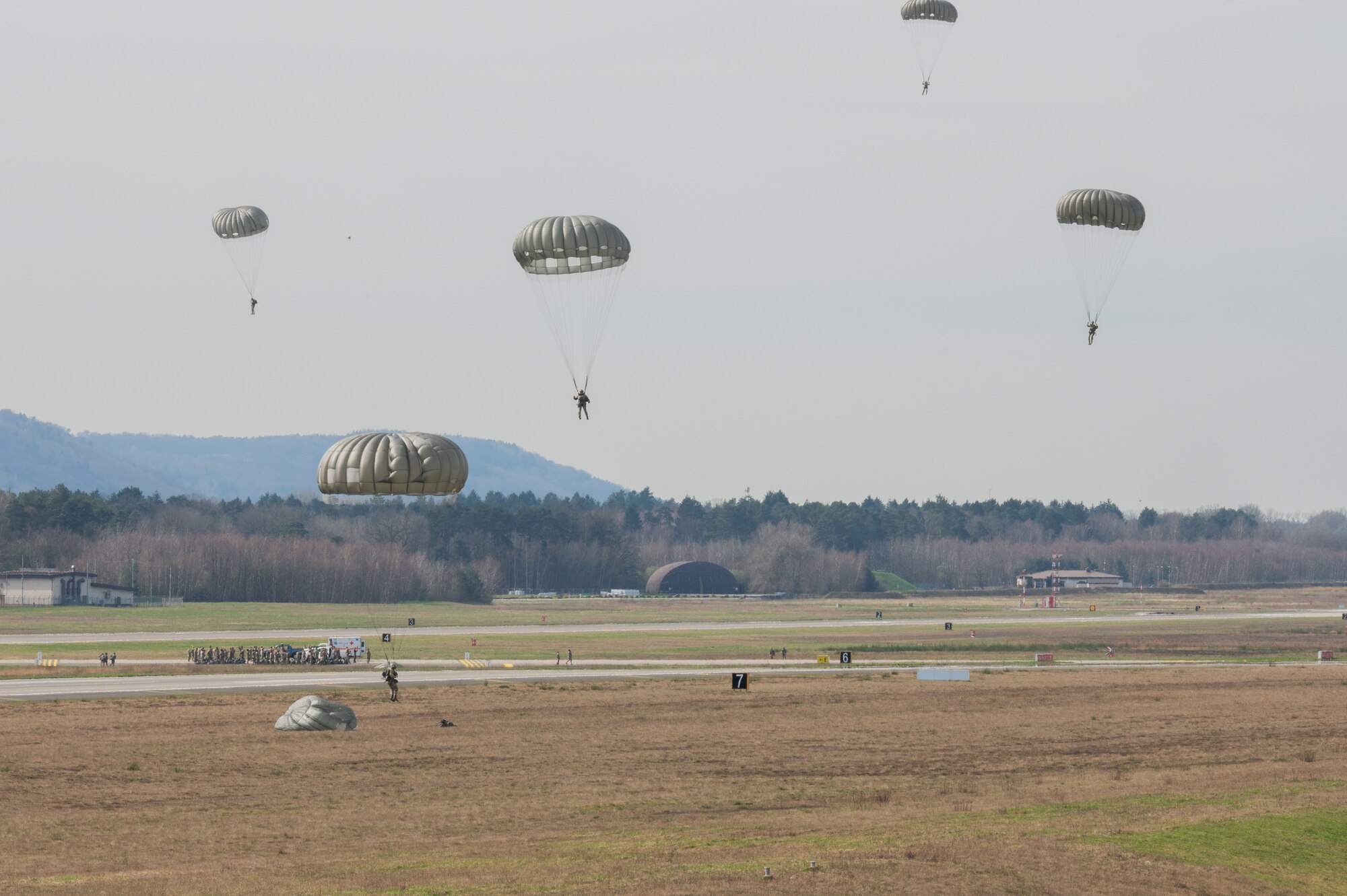 U.S. Air Force and U.S. Army jumpers land after a jump during a Fly Like a Girl event at Ramstein Air Base, Germany, March 20, 2024.