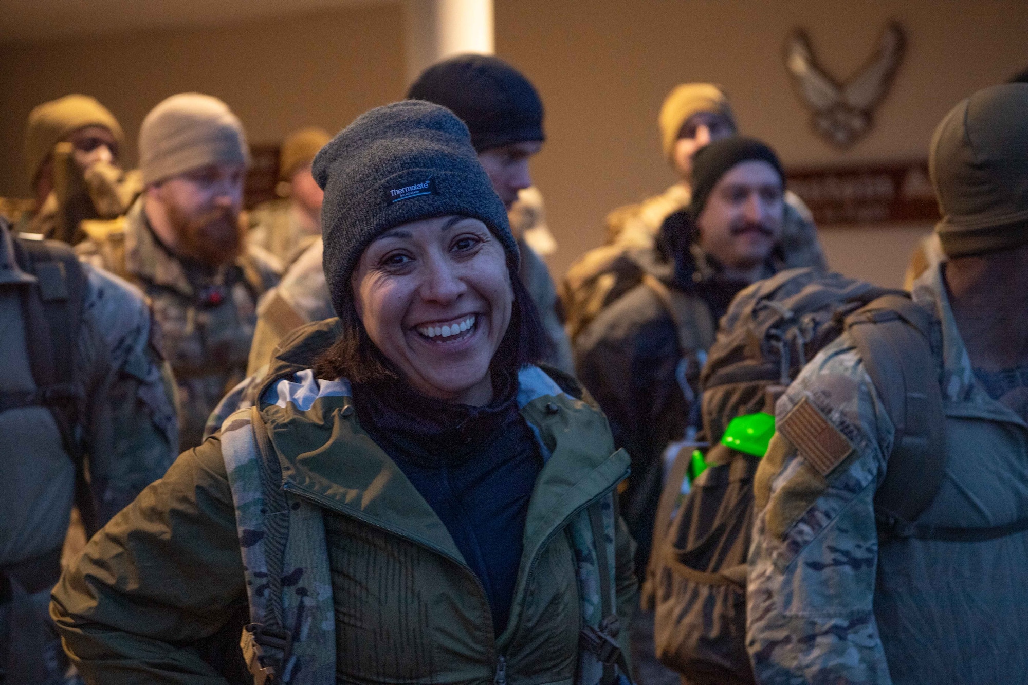 Airman smiles while preparing for a ruck to celebrate Women’s History Month