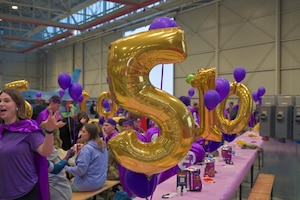 Balloons are displayed over a table.