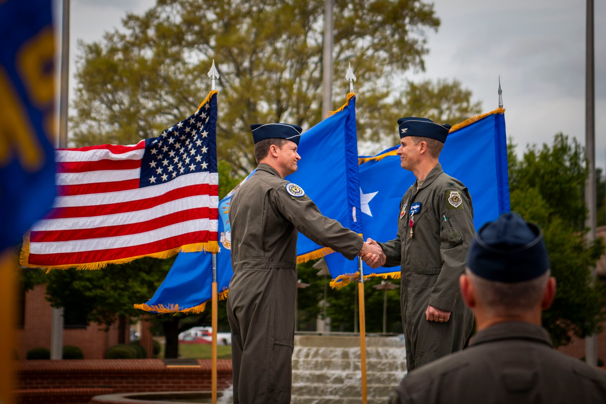 Maj. Gen. David Lyons, Fifteenth Air Force commander, gives the meritorious service pin to Col. Lucas Teel, 4th Fighter Wing commander, during the 4th FW change of command, at Seymour Johnson Air Force Base, North Carolina, March 22, 2024. The Meritorious Service Medal may be awarded to any member of the armed forces of the United States who distinguished themselves by either outstanding achievement or meritorious service to the United States. (U.S Air Force photo by Senior Airman Sabrina Fuller-Judd)