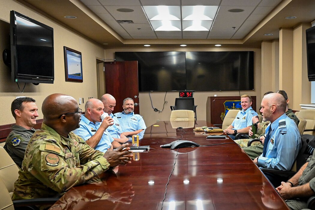 U.S. Air Force and Royal New Zealand Air Force leadership speak with each other in a conference room