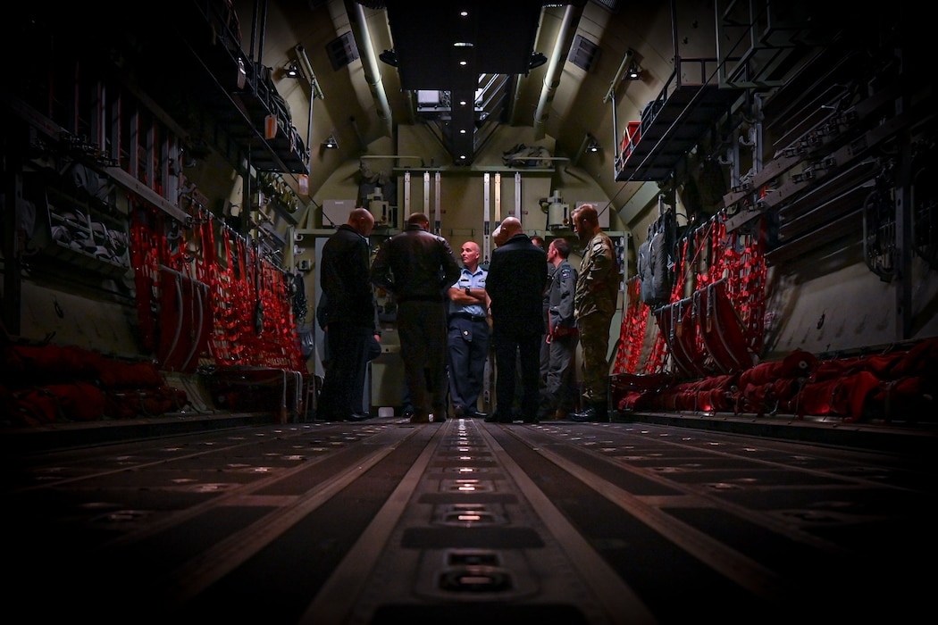 Royal New Zealand Air Force leadership walk around the inside of an aircraft trainer