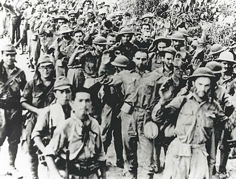 U.S. Army National Guard and Filipino soldiers march together en masse   during the Bataan Death March during World War II.