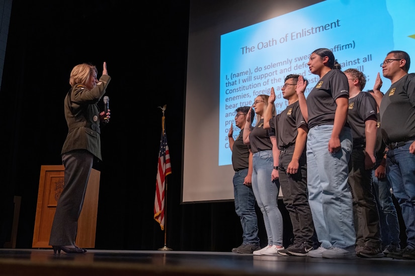 A military officer gives the oath of enlistment to a group of students.