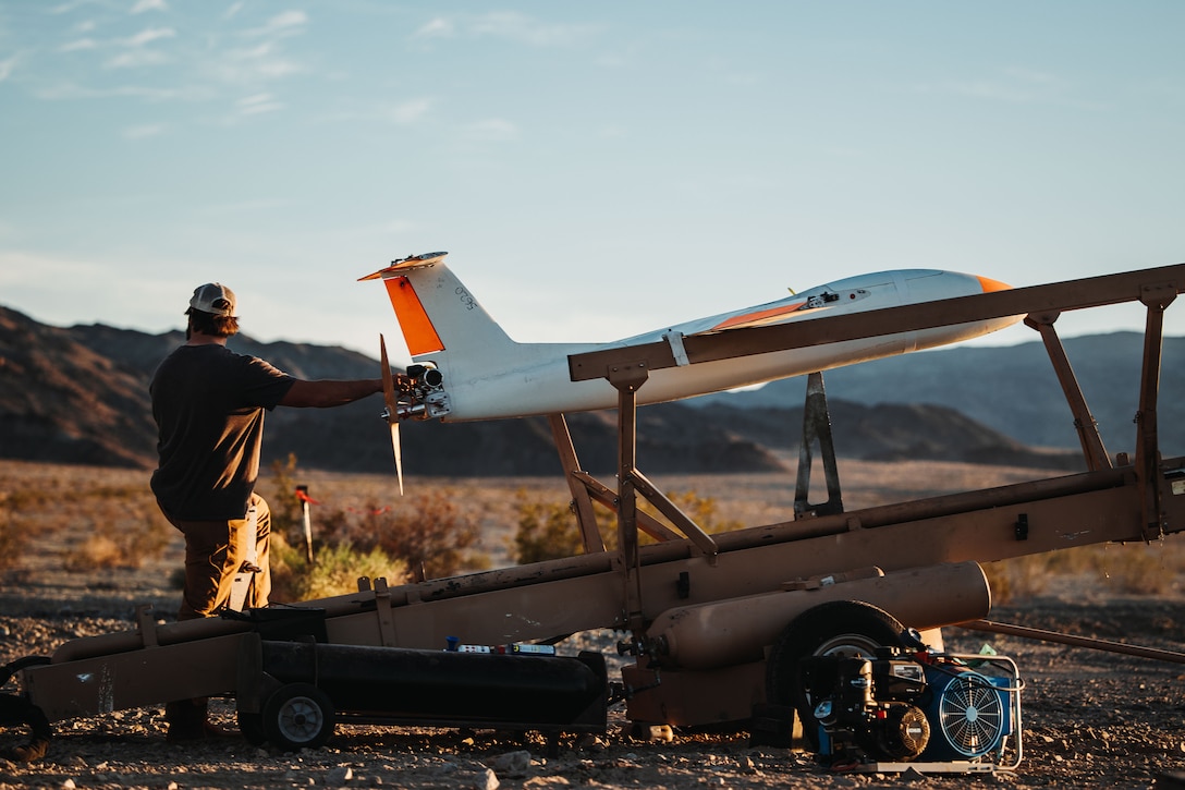 Austin French, a drone technician with Griffon Aerospace, starts up a drone target during a stinger live-fire exercise as part of Service Level Training Exercise 2-24 at training area Lead Mountain, Marine Corps-Air Ground Combat Center, Twentynine Palms, California, March 5, 2024. Low Altitude Air Defense Training Section conducted surface-to-air weapons fires on drones in order to complete directed training and readiness events while simulating a real-world scenario for students. (U.S. Marine Corps video by Lance Cpl. Richard PerezGarcia)