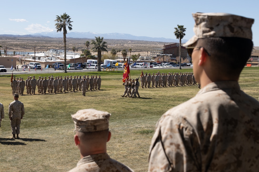 U.S. Marines with 3rd Battalion, 4th Marine Regiment (REIN), 7th Marine Regiment, 1st Marine Division, stand at attention as the colors are marched during a V34 relief and appointment ceremony at Lance Cpl. Torrey L. Gray Field, Marine Corps Air-Ground Combat Center, Twentynine Palms, California, March 8, 2024. The ceremony showcases the official changeover of sergeants major, commemorating the departure of Sgt. Maj. Trevor Goff, while welcoming the oncoming sergeant major, Sgt. Maj. Nathan Aja to his new command. (U.S. Marine Corps photo by Lance Cpl. Enge You)