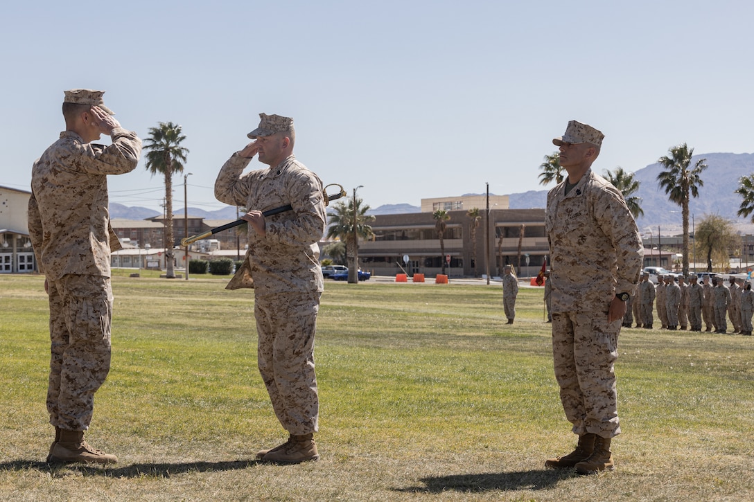 U.S. Marine Corps Lt. Col. Bryceson Tenold, a Spokane, Washington native, commanding officer of 3rd Battalion, 4th Marine Regiment (REIN), 7th Marine Regiment, 1st Marine Division, left, returns a salute from Sgt. Maj. Trevor Goff, a Kalamazoo, Michigan native, departing sergeant major of V34, 1st Marine Division, center, during a V34 relief and appointment ceremony at Lance Cpl. Torrey L. Gray Field, Marine Corps Air-Ground Combat Center, Twentynine Palms, California, March 8, 2024. The ceremony showcases the official changeover of sergeants major, commemorating the departure of Goff, while welcoming the oncoming sergeant major, Sgt. Maj. Nathan Aja to his new command. (U.S. Marine Corps photo by Lance Cpl. Enge You)