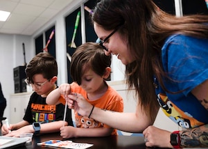 Parents and children work on a project.