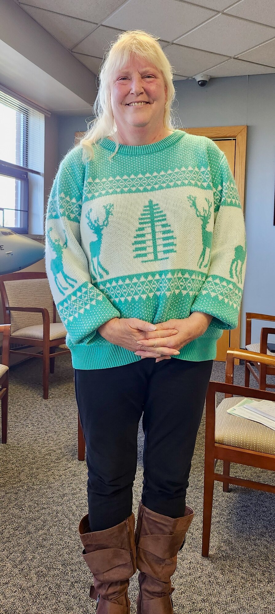 Ms. Diane Piquette stands in front of a model of a C-5M Super Galaxy in the wing headquarters building.  Piquette will become the Patriot Wing's first-ever woman comptroller and Chief of Finance on April 7, 2024.