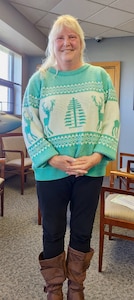 Ms. Diane Piquette stands in front of a model of a C-5M Super Galaxy in the wing headquarters building.  Piquette will become the Patriot Wing's first-ever woman comptroller and Chief of Finance on April 7, 2024.